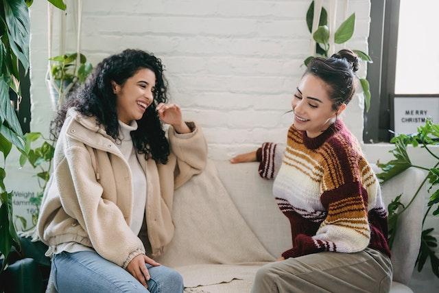 two friends talking and smiling