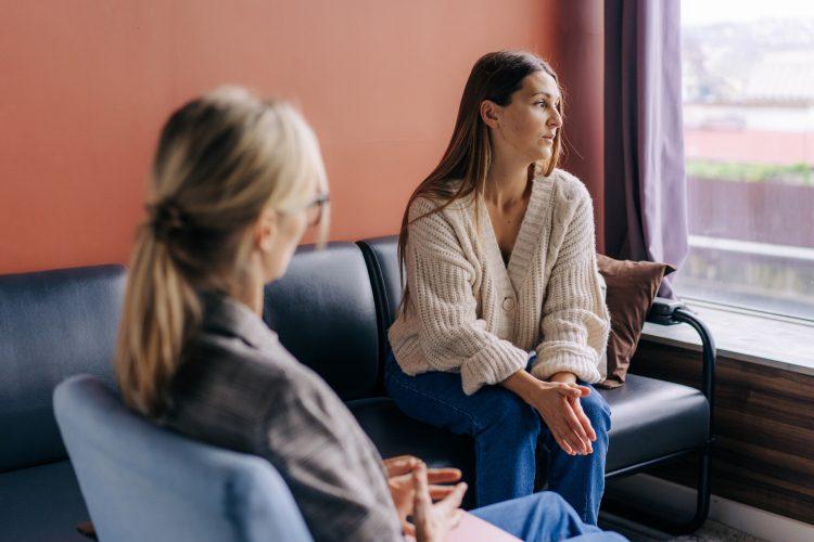 sad-frustrated-woman-talking-in-a-session-with trauma therapist Trauma therapy